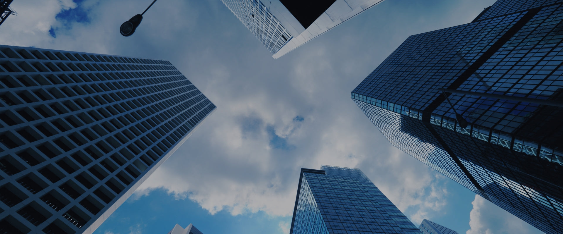 Upward view of modern city buildings symbolizing global business growth, partnerships, and international market reach